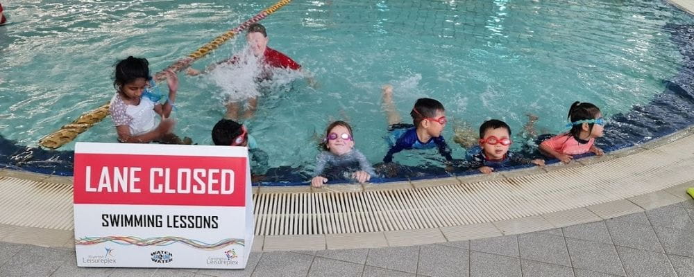 Multicultural children in the pool at the swimming lesson