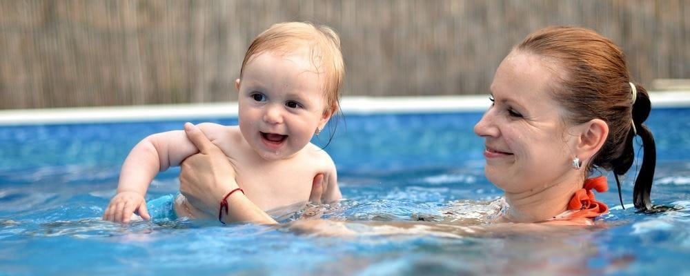 image of woman with baby in a pool