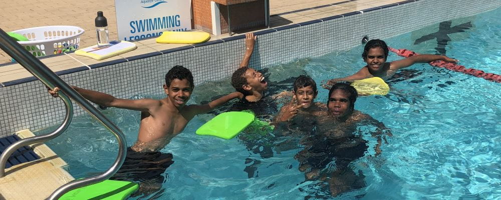 Five aboriginal boys having fun in the pool as part of the Swim and Survive lessons