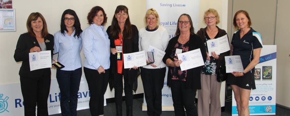 a group of community trainers with their awards