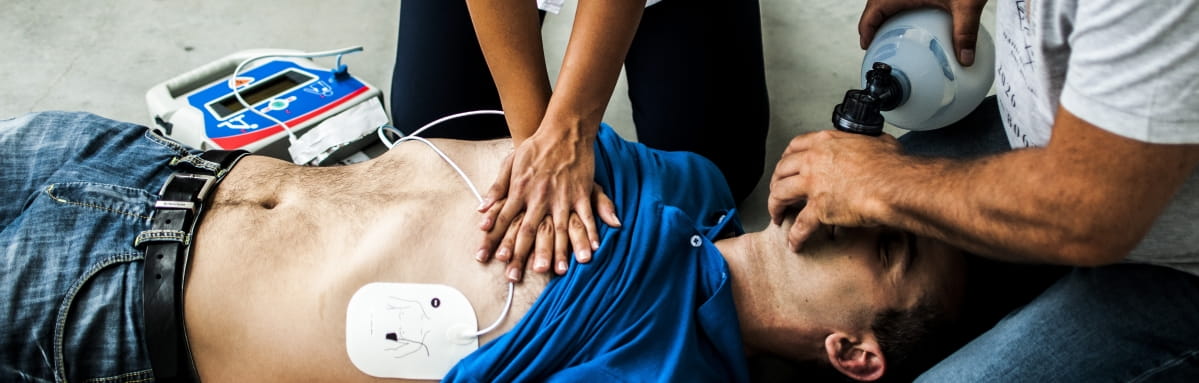 A CPR casualty is administered with care by two first aid practitioners