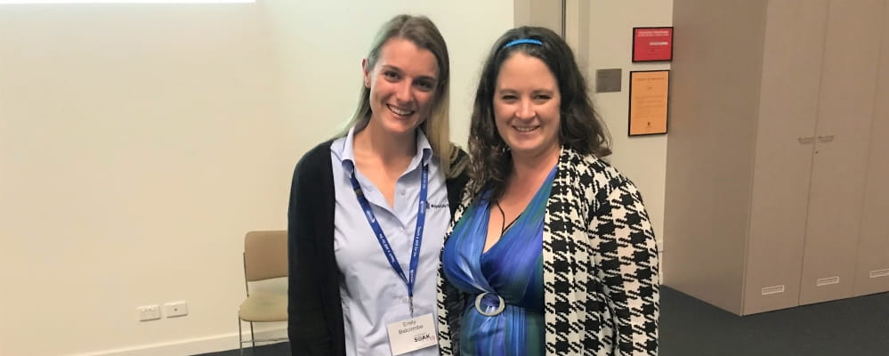 Emily Balcombe, RLSSWA Inclusion Coordinator, stands next to Amy Tyers at the Cultural Awareness Training program at UWA