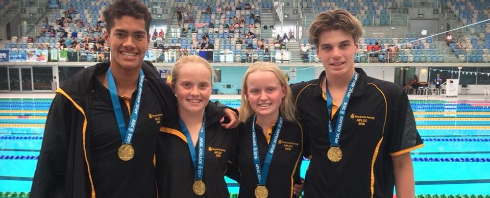 TJ Chong Sue, Chalice Pratt, Dayna Tindall and Harrison Hynes with theor gold medals by the pool at the Australian Pool Lifesaving Championships