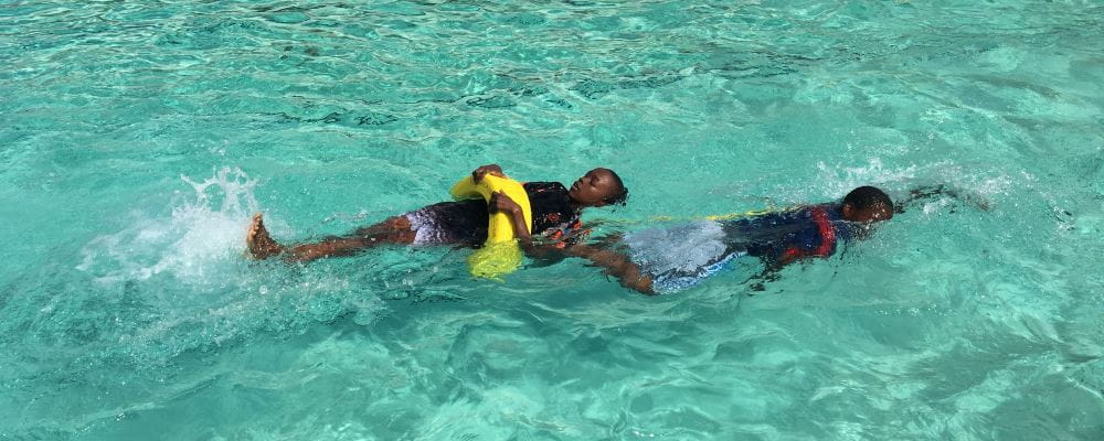 two boys lifesaving in the pool
