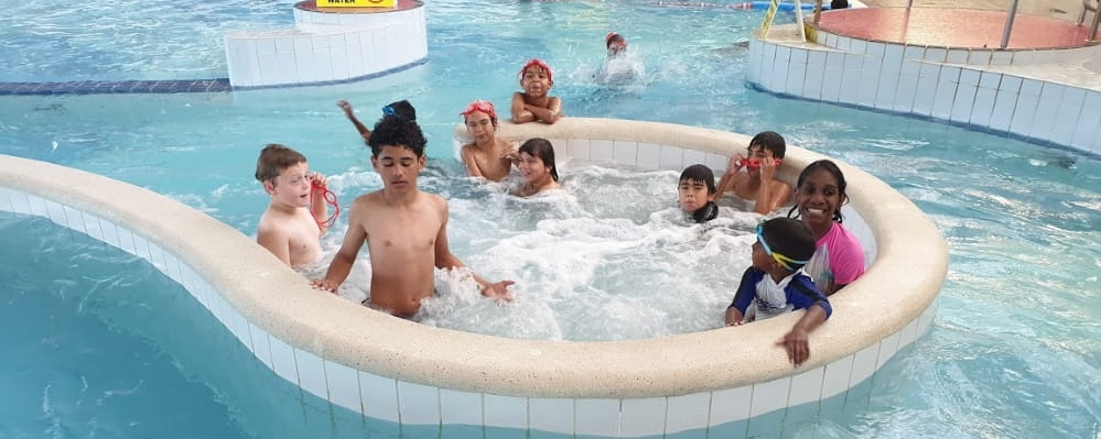 A group of Indigenous kids play in the pool as part of the recent Swim and Survive program in Balga