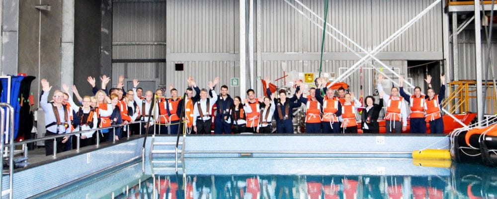 ERGT employees wearing lifejackets and standing by their training pool
