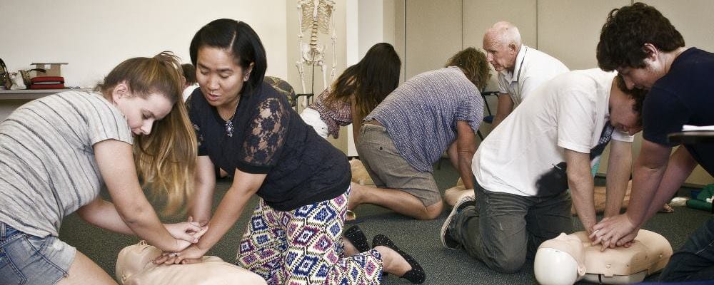 A group of people learning CPR in a first aid course