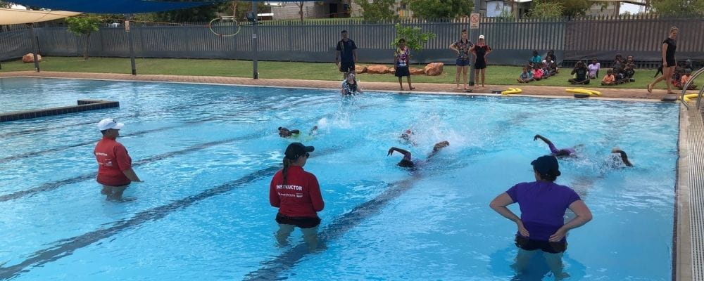 Instructors in the pool with Fitzroy Crossing kids