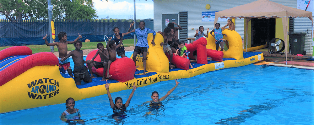 Local kids having fun on a giant pool inflatable at the Fitzroy Crossing pool