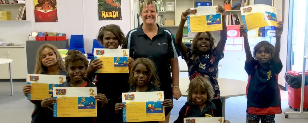 Adele Caporn from Fitzroy Pool with children from Wangkatjunka Community receiving certificates