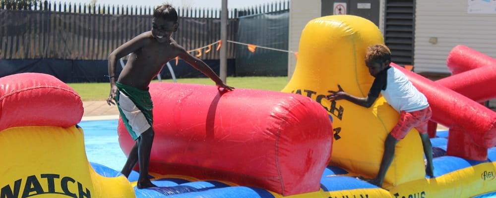 Two Aboriginal children on the pool inflatable at Fitzroy