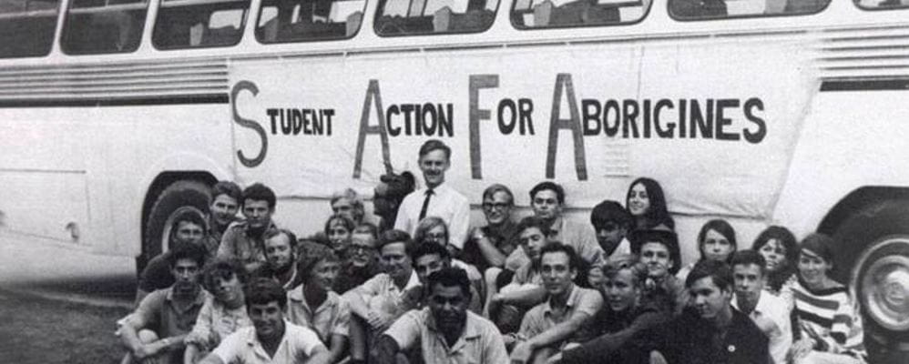 A group of people supporting Student Action For Aborigines sit near the bus they ride on as Freedom Riders