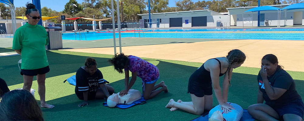 Female high school students learning CPR
