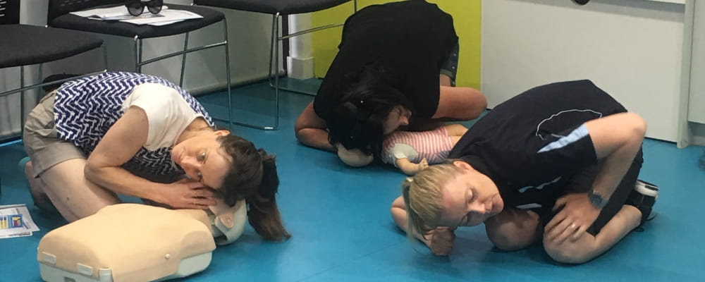 Parents practising CPR skills during a Heart Beat Club session