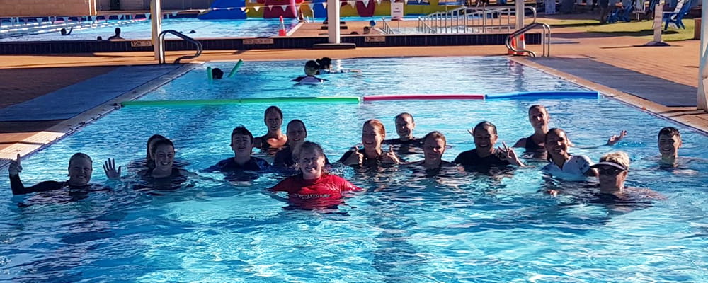 AUSTSWIM course participants in the water with their instructor at South Hedland Aquatic Centre