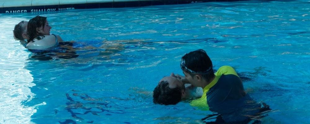 Image of two people practising rescues in the pool