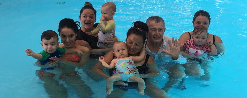 Laurie Lawrence in the water with mums and babies during an Infant Aquatics class