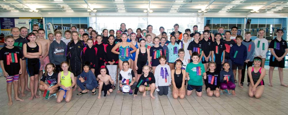 A group of Junior Lifeguard Club members gathering together by the pool at HBF Arena Joondalup
