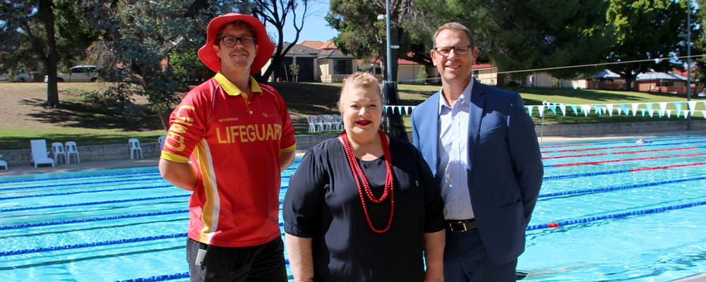 A pool lifeguard with Minister for Education and Training Sue Ellery and Royal Life Saving CEO Peter Leaversuch