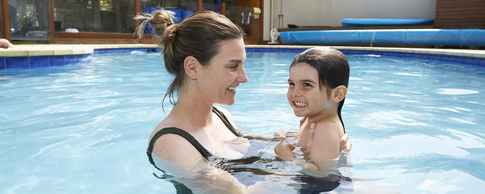 A mum with her toddler son in the pool