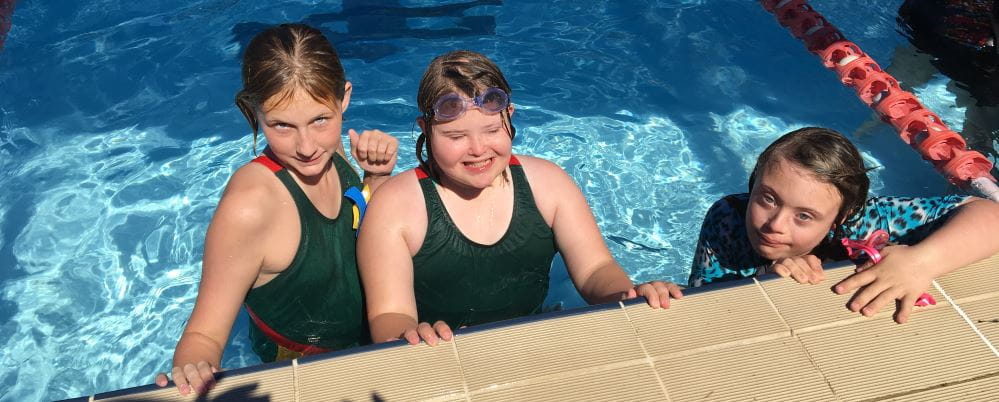 Three girls in the pool at the ACC Inclusion Swimming Carnival 