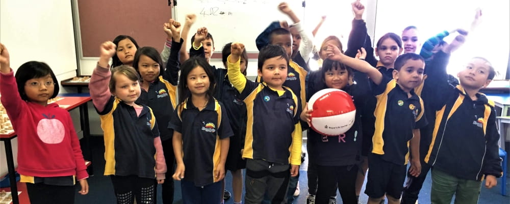 A group of kids at Koondoola primary celebrate learning  about swimming safety