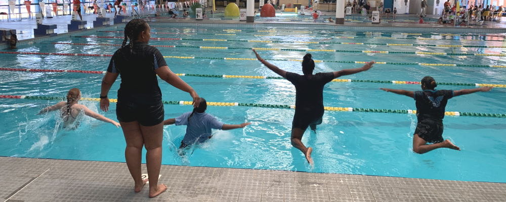 A group of Aboriginal girls jumping into the water at Swan Active Midland