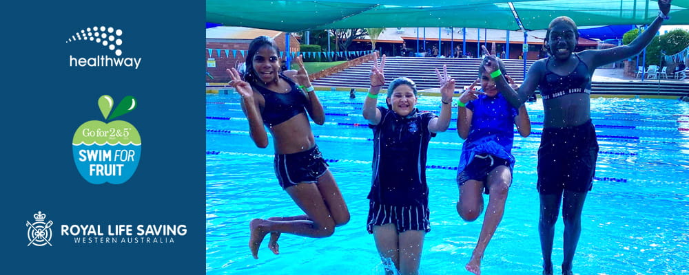 four girls jumping into a pool smiling