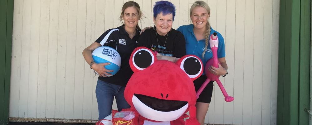 Leavers Volunteer Mel Hankin with Leeanne from Hope Community Services, Carley from the WA Aids Council and the Red Frogs Mascot!