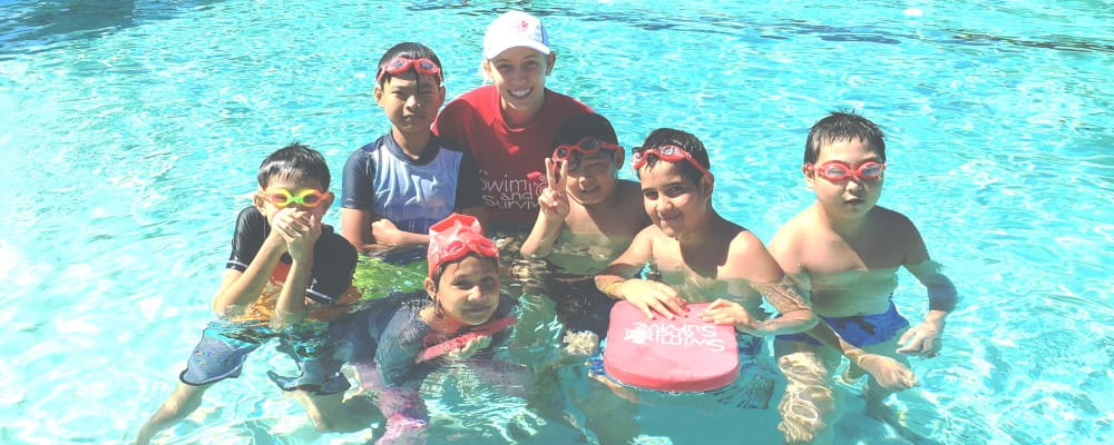 Lynwood children with a swim instructor in the pool