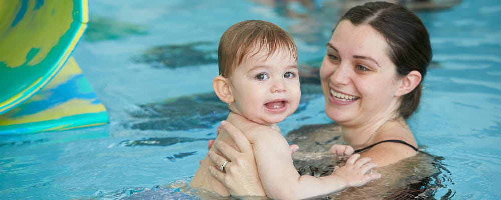 A mum and her baby boy in an infant aquatics class
