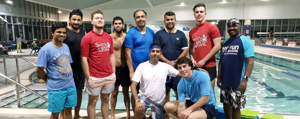 A group of men with their swim instructors by the pool at Cannington Leisureplex