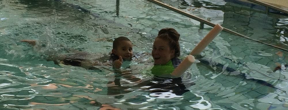 Nehana Porter in the water with his swimming instructor at Aquamotion Wanneroo