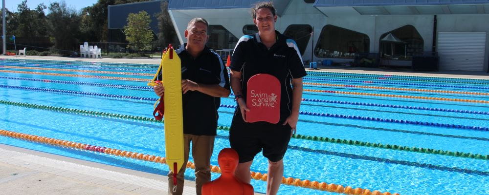 David Lucas and Mel Warren by the pool at HBF Stadium holding rescue gear