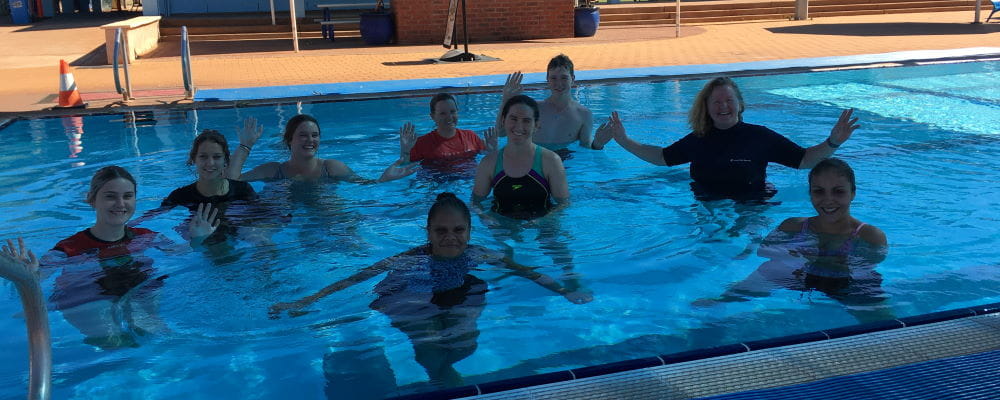 A group of swim instructor trainees in the pool with their teacher at Port Hedland