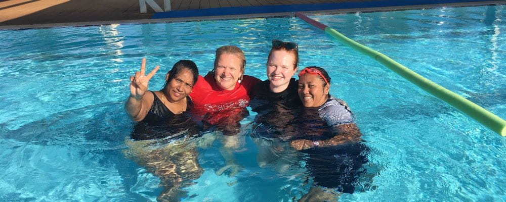 Two multicultural women with swim instructor Justine and daughter Ruby in the pool at Port Hedland