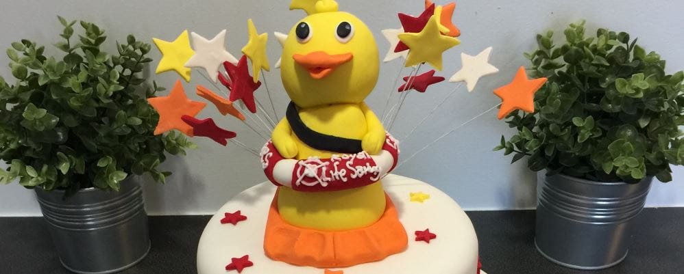 A quackers duck shaped cake celebrating a one million dollar milestone reached