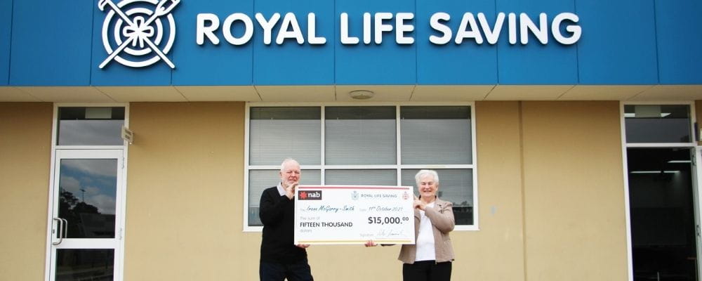 Raffle winner Irene with husban Dick holding their winners cheque outside the Royal Life saving building