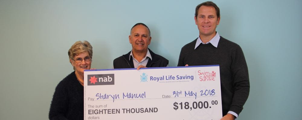 Raffle winner Sharyn Manuel with husband Neil and RLSSWA CEO Peter Leaversuch, holding a giant winners cheque