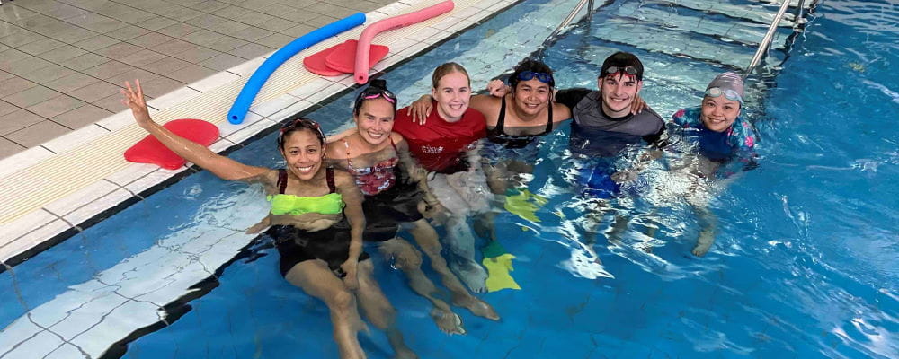 Adults in a swimming class