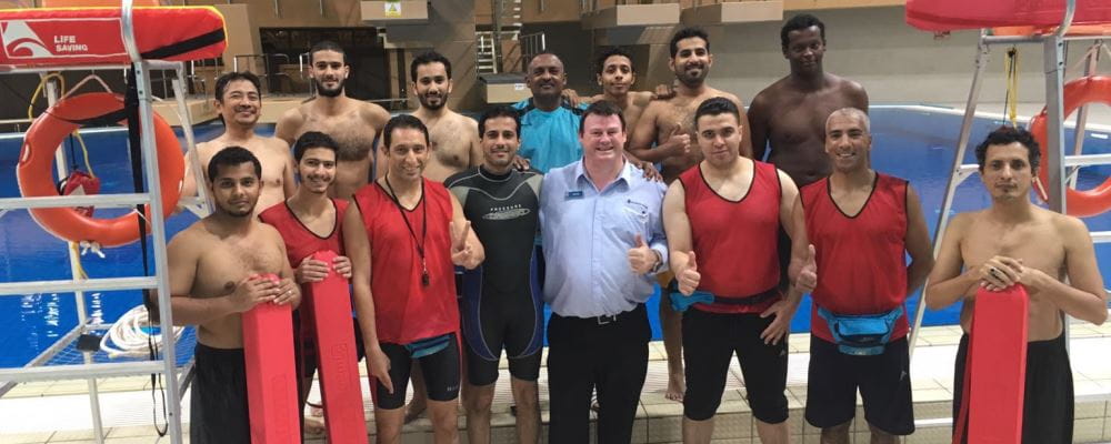 Image of Saudi lifeguards with RLSSWA's Steve Good by the pool