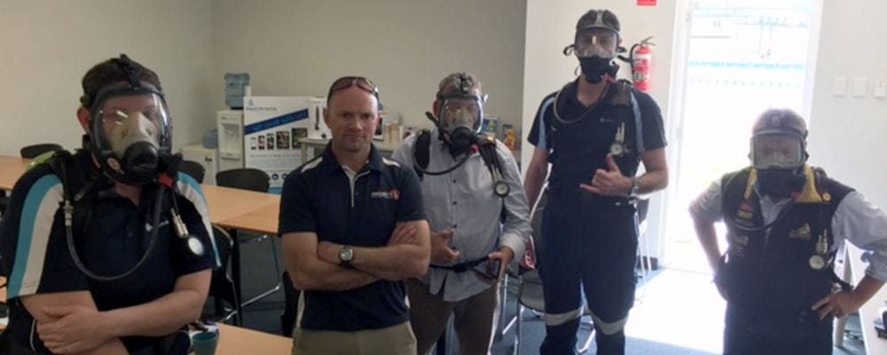 Four Royal Life Saving staff with their Priority 1 trainer wearing SCBA masks