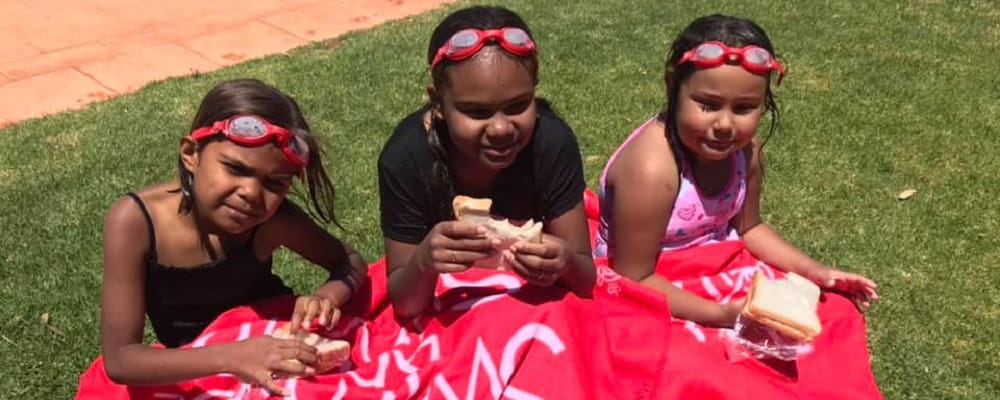 three girls enjoying a sandwich at the Mt Magnet pool