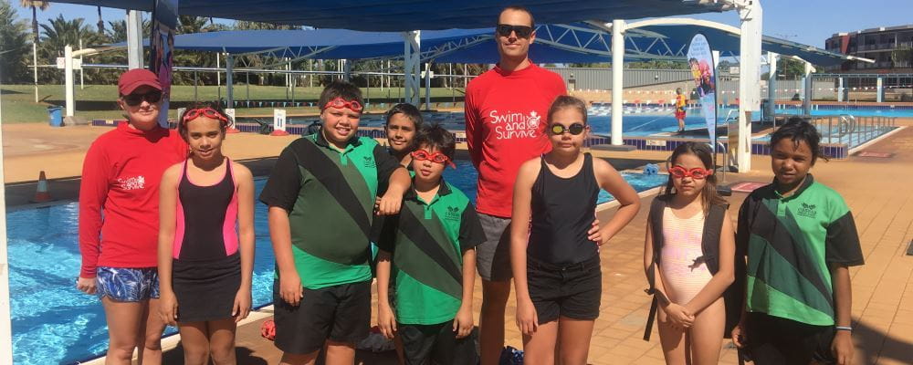 group of children with two swim instructors at South Hedland swimming pool