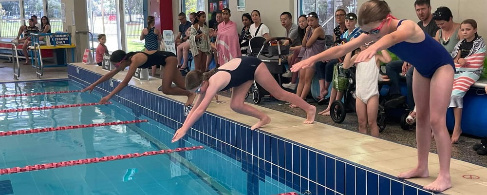 participants at the 2021 Swan Active JLC Carnival diving into the pool