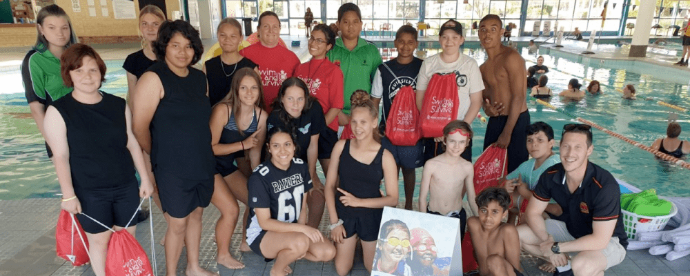 A group of Aboriginal youth wth their swim instructors and teachers by the pool at Swan Active Midland