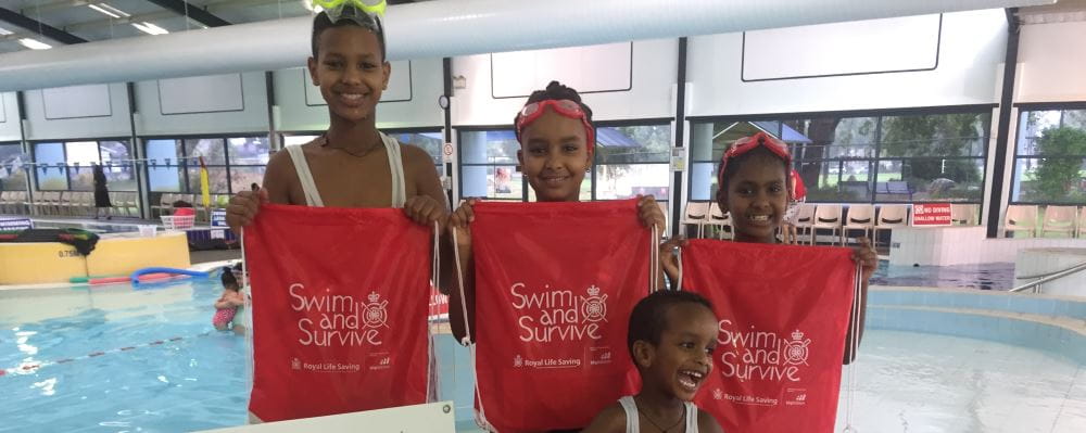 Four children with swim and survive bags