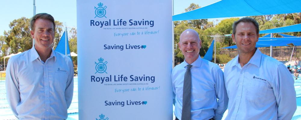 Royal Life Saving WA's Trent Hotchkin, Member for Churchlands Sean L'Estrange and Royal Life Saving WA CEO Peter Leaversuch in front of the pool at Bold Park Aquatic Centre