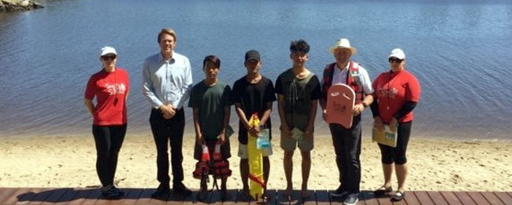 Swim instructors and multicultural participants with MP Steve Irons and RLSSWA's Trent Hotchkin by the Swan River