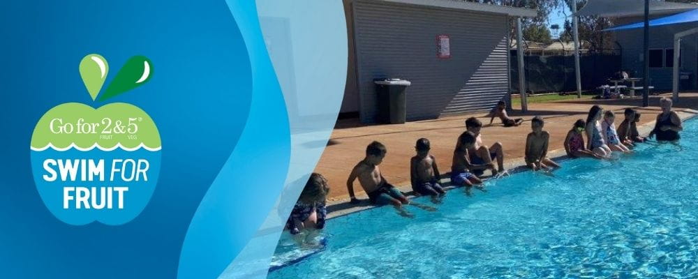 Children lined up on the edge of the pool with their swim teacher in Laverton